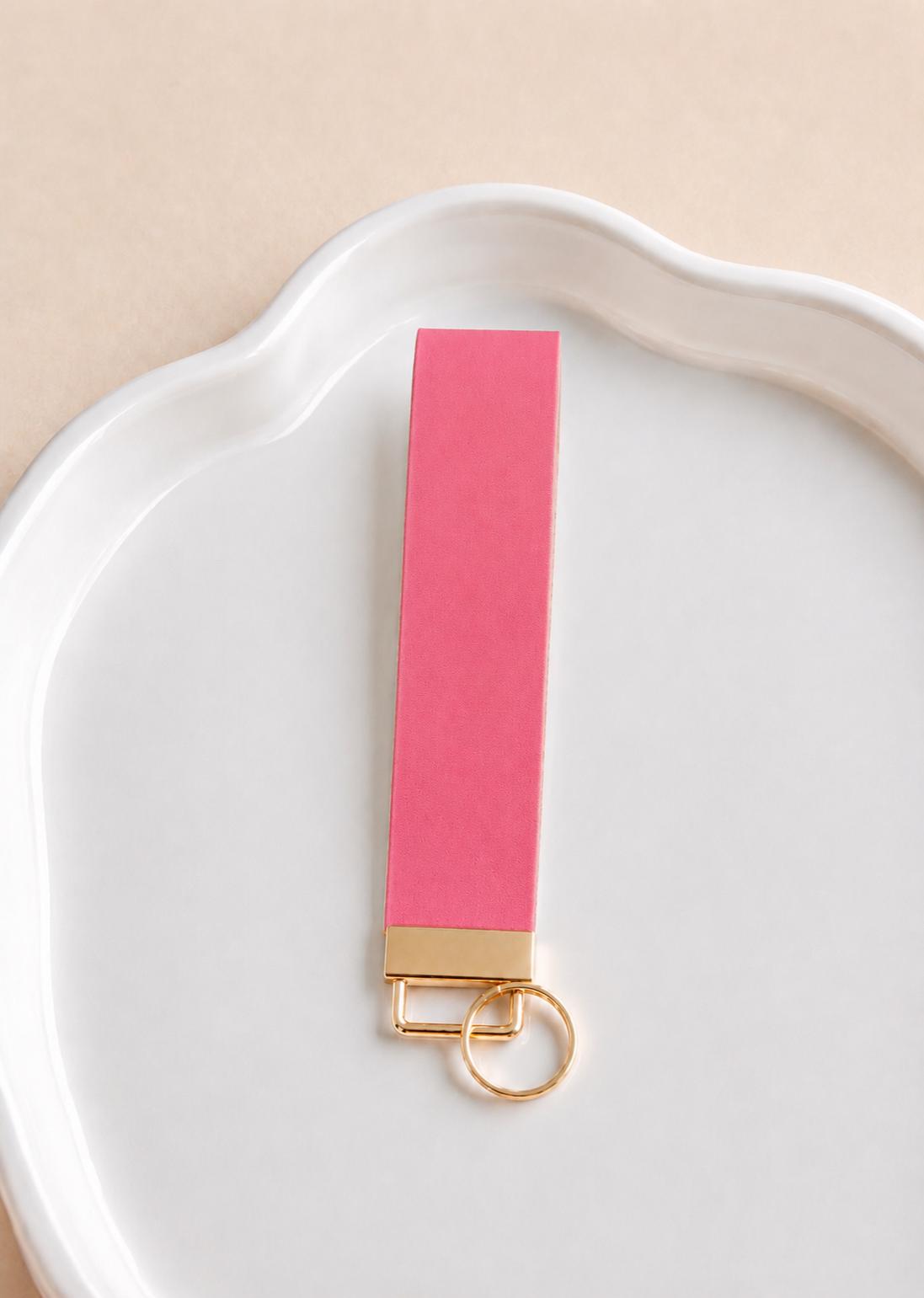 Hot pink faux leather wristlet keychain held at sunset by Sundazed — Petal Pink Wristlet
